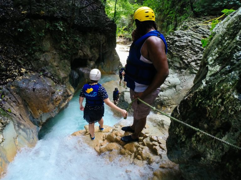 Adventurer descending 27 Waterfalls of Damajagua (Los 27 Charcos), Puerto Plata, Dominican Republic, with a guide.